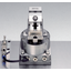 Automated transfer of workpiece exchange and movement between processing machines using a precision vise.
