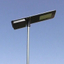 Large solar-powered LED streetlight with automatic dimming at midnight and extended battery lifespan.